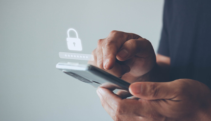 Hand holding a phone with a secure lock floating above the phone.