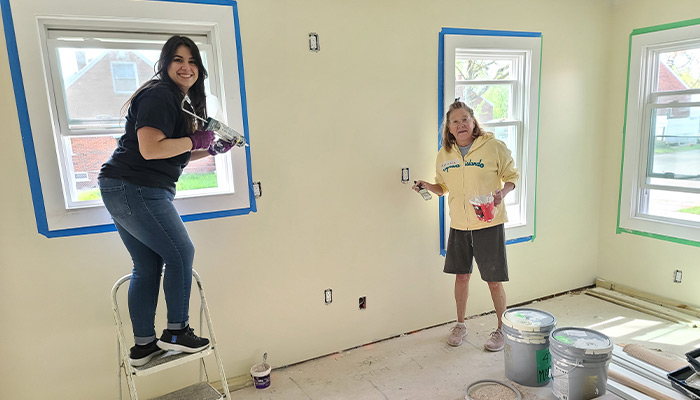 First Merchants Team Members painting the upstairs living room.