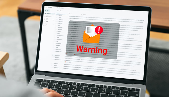 Computer screen with a email warning icon displaying in the middle.