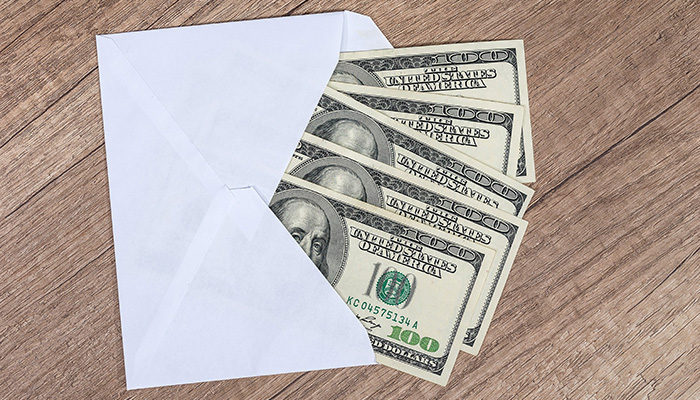 Envelope with five $100 bills