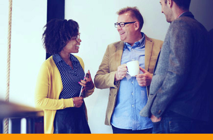 Picture of three people talking and smiling